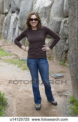 Woman standing in a narrow alley, Sacsayhuaman, Sacred Valley, Cusco Region, Peru View Large Photo Image Stock Photography - Woman standing in a narrow alley, Sacsayhuaman, Sacred Valley, Cusco Region, Peru. Fotosearch