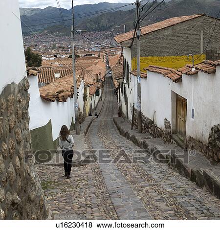 Woman walking in a village street, Sacred Valley, Cusco Region, Peru View Large Photo Image Stock Photo - Woman walking in a village street, Sacred Valley, Cusco Region, Peru. Fotosearch
