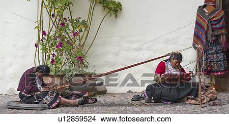 Picture - Women sitting in front of an art museum, Museo De Arte Precolombino, Cuzco, Peru. Fotosearch