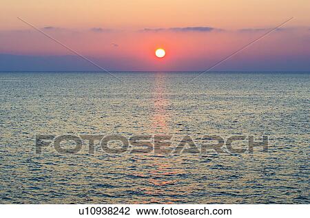 Stock Image - Aegean Sea horizon at sunset. Fotosearch