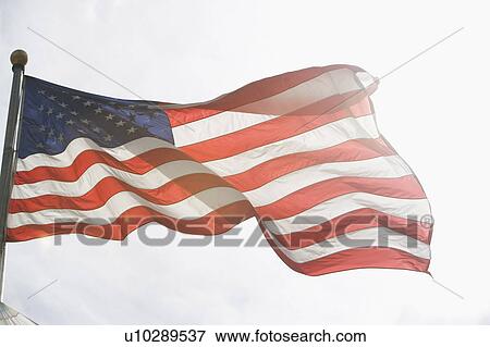 American flag against sky View Large Photo Image Stock Photo - American flag against sky. Fotosearch