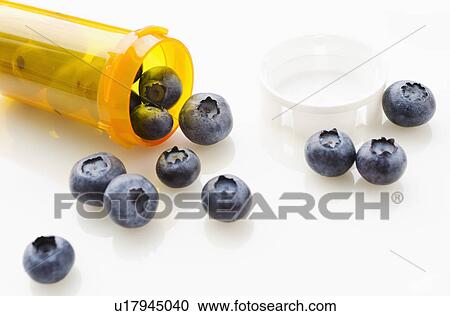Blueberries spilling from prescription bottle View Large Photo Image Stock Image - Blueberries spilling from prescription bottle. Fotosearch