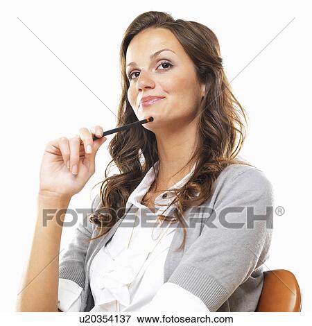 Bored business woman sitting on chair with pencil against white background View Large Photo Image Stock Photo - Bored business woman sitting on chair with pencil against white background. Fotosearch