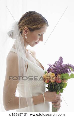 Bride holding floral bouquet View Large Photo Image Stock Image - Bride holding floral bouquet. Fotosearch