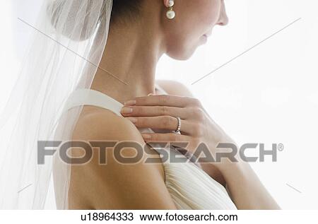 Stock Image - Bride wearing veil. Fotosearch