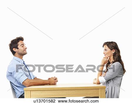 Business couple sitting at table for date View Large Photo Image Stock Image - Business couple sitting at table for date. Fotosearch