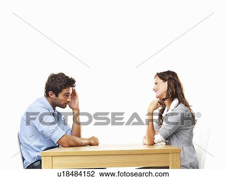Business couple sitting at table for date View Large Photo Image Stock Image - Business couple sitting at table for date. Fotosearch
