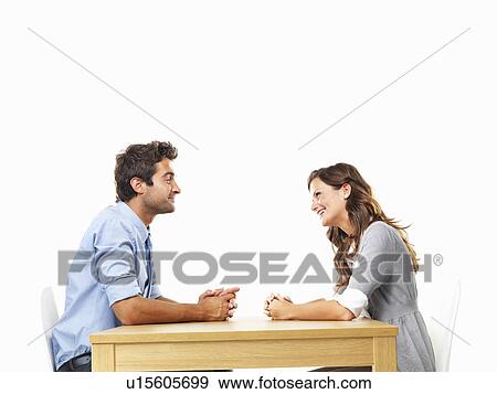 Business couple sitting at table for date View Large Photo Image Stock Photo - Business couple sitting at table for date. Fotosearch