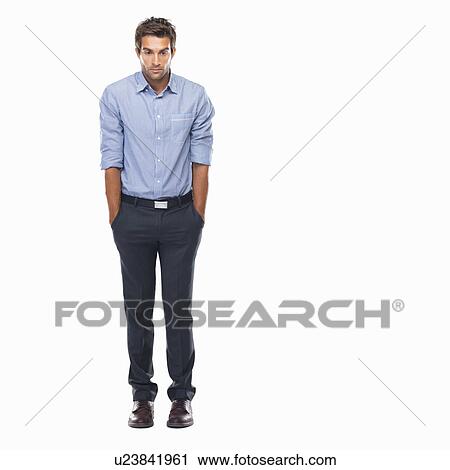 Stock Image - Business man standing with hands in pockets and looking down. Fotosearch