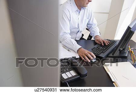 Stock Image - Businessman at work. Fotosearch