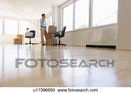 Stock Photography - Businessman setting up office. Fotosearch
