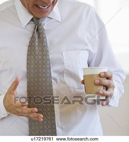 Businessman spilling coffee on shirt View Large Photo Image Stock Image - Businessman spilling coffee on shirt. Fotosearch