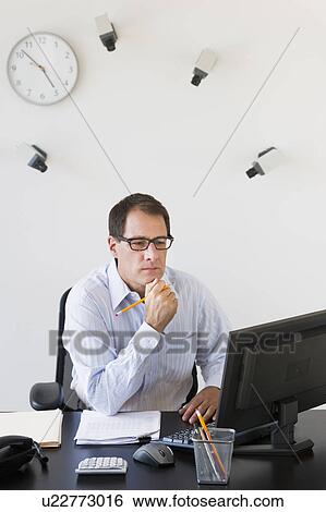 Stock Photograph - Businessman under surveillance of security cameras. Fotosearch