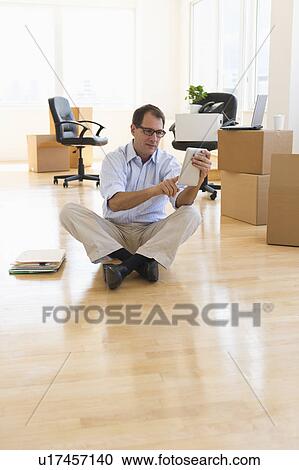 Businessman using palmtop in new office View Large Photo Image Stock Image - Businessman using palmtop in new office. Fotosearch