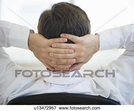 Businessman with hands behind head View Large Photo Image Stock Photo - Businessman with hands behind head. Fotosearch