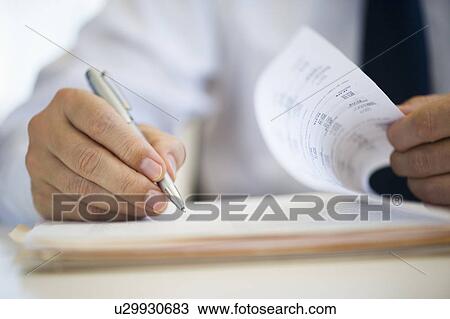 Stock Image - Businessman writing, close-up. Fotosearch