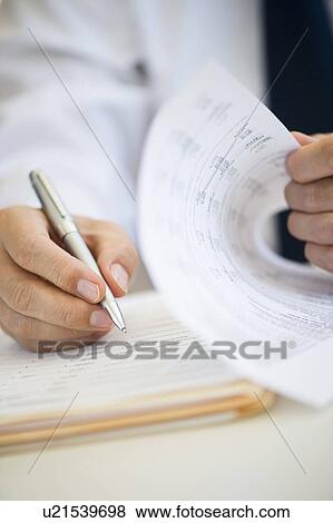 Stock Photo - Businessman writing, close-up. Fotosearch