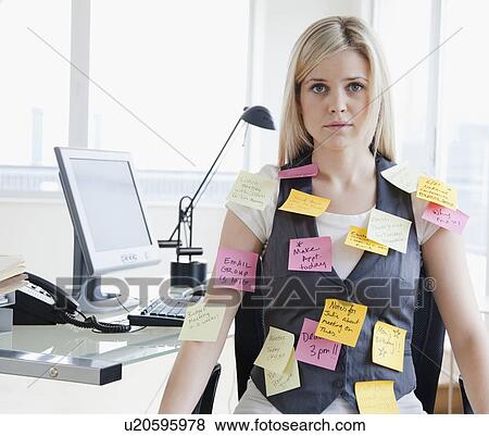 Stock Photo - Businesswoman with memo notes on clothes. Fotosearch
