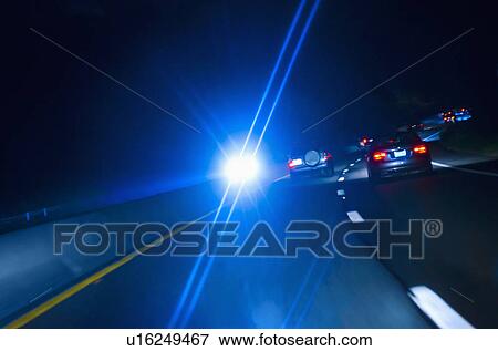 Car headlights on road at night View Large Photo Image Stock Photo - Car headlights on road at night. Fotosearch