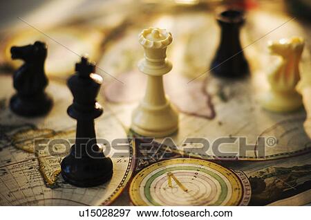 Chess pieces on old world map View Large Photo Image Stock Photo - Chess pieces on old world map. Fotosearch