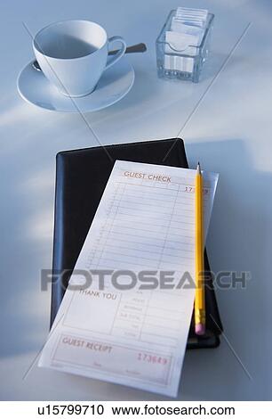 Stock Image - Close up of bill in restaurant. Fotosearch