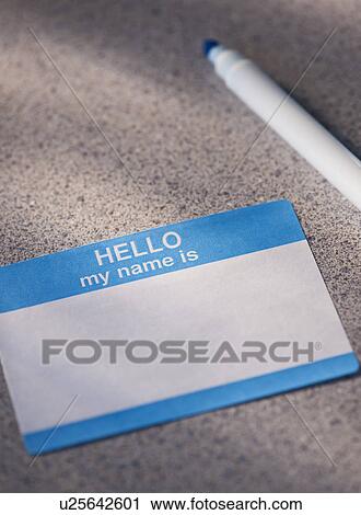 Stock Image - Close up of blank name tag and pen. Fotosearch