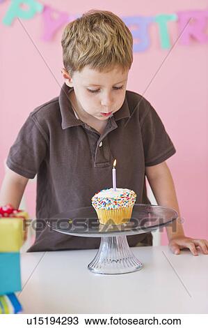 Stock Image - Close up of boy (4-5) celebrating birthday. Fotosearch