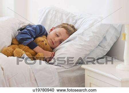 Close up of boy (4-5) sleeping in bed View Large Photo Image Stock Image - Close up of boy (4-5) sleeping in bed. Fotosearch