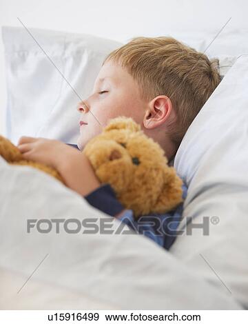 Stock Photo - Close up of boy (4-5) sleeping in bed. Fotosearch