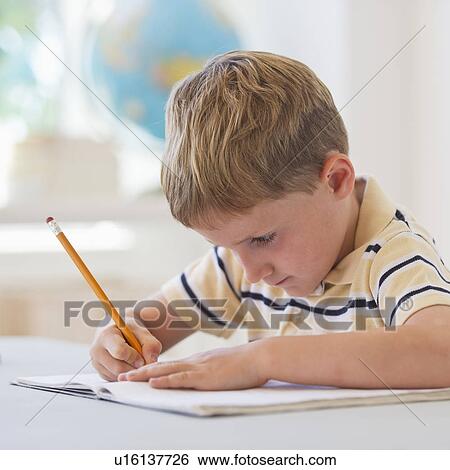 Stock Photograph - Close up of boy (4-5) writing in notebook. Fotosearch