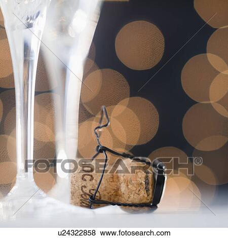 Close up of champagne flutes and cork View Large Photo Image Stock Photo - Close up of champagne flutes and cork. Fotosearch