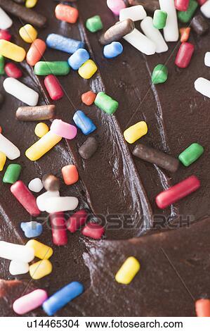 Close up of chocolate cake with sprinkles View Large Photo Image Picture - Close up of chocolate cake with sprinkles. Fotosearch