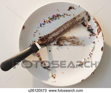 Stock Image - Close up of empty plate with rests of chocolate and sprinkles. Fotosearch