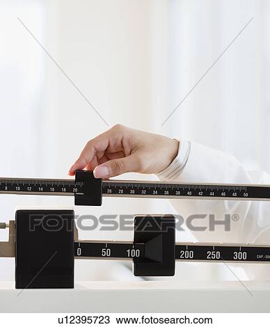 Close up of female doctor's hand holding scale View Large Photo Image Stock Image - Close up of female doctor's hand holding scale. Fotosearch