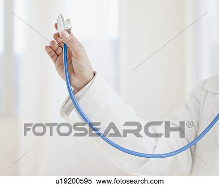 Close up of female doctor's hand holding stethoscope View Large Photo Image Stock Photography - Close up of female doctor's hand holding stethoscope. Fotosearch