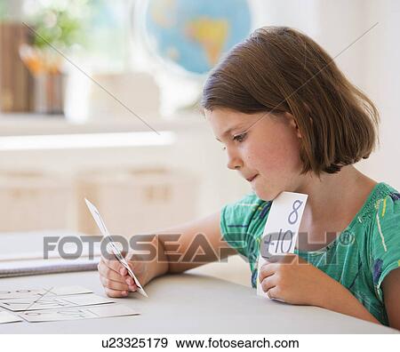 Close up of girl (6-7) counting in classroom View Large Photo Image Stock Photo - Close up of girl (6-7) counting in classroom. Fotosearch