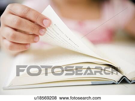 Close up of girl's (8-9) hand turning pages View Large Photo Image Stock Photo - Close up of girl's (8-9) hand turning pages. Fotosearch