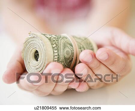 Close up of girl's (8-9) hands holding money roll View Large Photo Image Stock Photography - Close up of girl's (8-9) hands holding money roll. Fotosearch