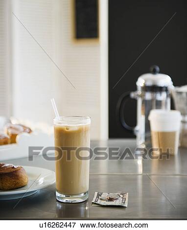 Close up of glass of iced coffee and money on table in coffee shop View Large Photo Image Stock Photo - Close up of glass of iced coffee and money on table in coffee shop. Fotosearch