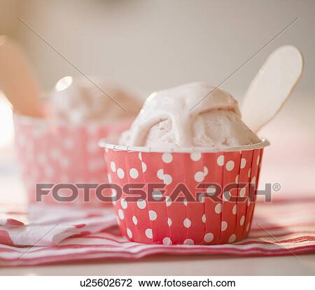 Stock Image - Close up of ice cream in colorful cups. Fotosearch