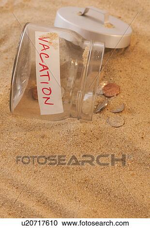 Close up of jar with coins spilled on sand View Large Photo Image Stock Image - Close up of jar with coins spilled on sand. Fotosearch