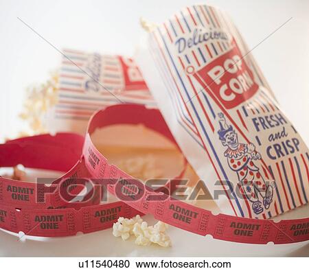 Stock Image - Close up of popcorn and tickets. Fotosearch