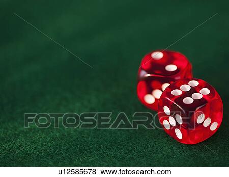 Stock Photo - Close up of red dices on green felt. Fotosearch