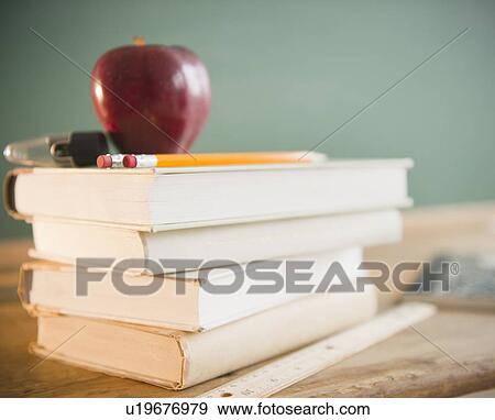 Close up of school equipment with books and apple View Large Photo Image Stock Photo - Close up of school equipment with books and apple. Fotosearch