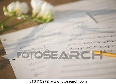 Stock Image - Close up of sheet music and flowers. Fotosearch