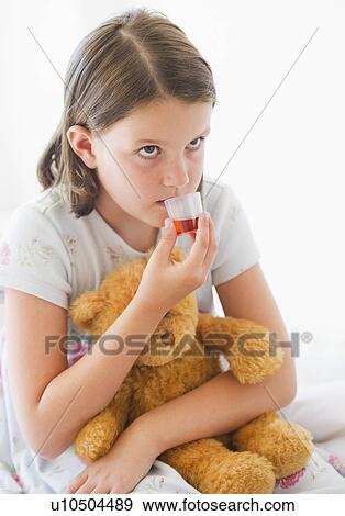 Close up of sick girl (6-7) with teddy bear drinking medicament View Large Photo Image Stock Photo - Close up of sick girl (6-7) with teddy bear drinking medicament. Fotosearch