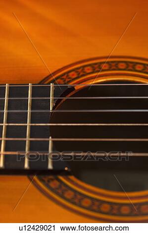 Close up of sound hole of acoustic guitar View Large Photo Image Stock Image - Close up of sound hole of acoustic guitar. Fotosearch