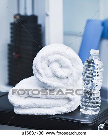 Close up of towel and bottle in gym View Large Photo Image Stock Photo - Close up of towel and bottle in gym. Fotosearch
