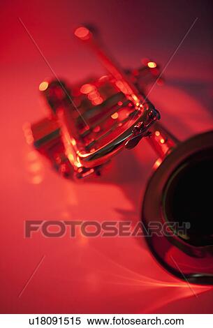 Stock Photography - Close up of trumpet on red background. Fotosearch
