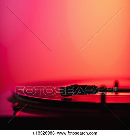 Stock Image - Close up of turntable on colored background. Fotosearch